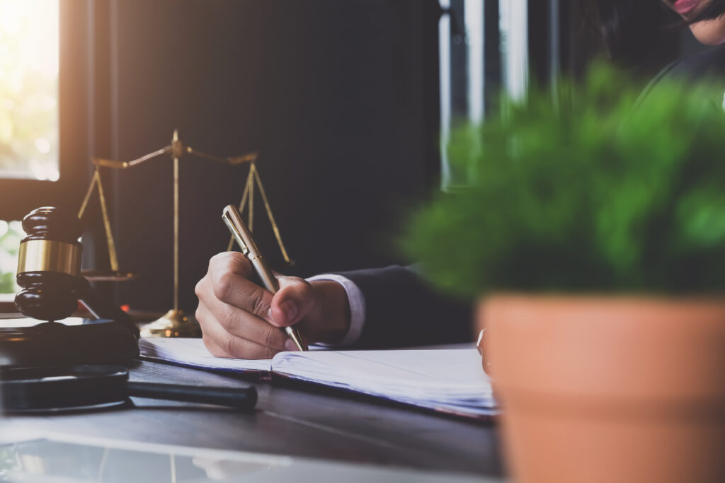 advice and justice concept. justice scales and justice hammer and female lawyer use pen, working legal law at lawyer office. advice and justice concept. justice scales and justice hammer and female lawyer use pen, working legal law at lawyer office.